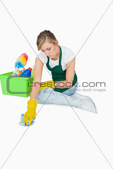 Young maid cleaning floor