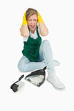 Tired maid screaming as she sits with brush and dust pan