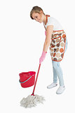 Young maid mopping floor