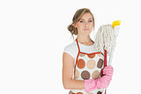Portrait of young woman with cleaning supplies
