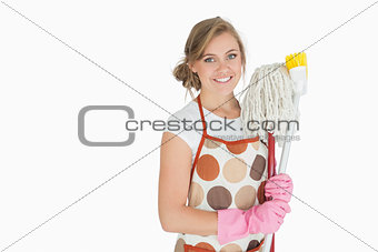 Portrait of smiling woman with cleaning supplies