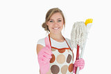 Portrait of maid with cleaning supplies gesturing thumbs up sign