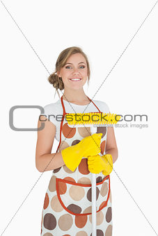 Portrait of smiling young woman with broom