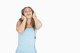 Young woman enjoying music over headphones