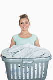 Portrait of smiling woman carrying laundry basket