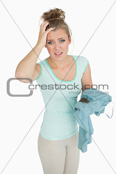 Portrait of displeased young woman with stained shirt