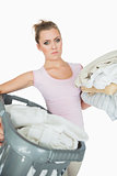 Portrait of young woman carrying laundry basket