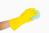 Closeup of yellow gloved hand using sponge
