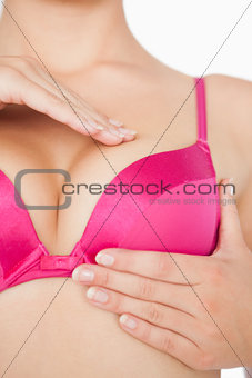 Woman performing self breast examination
