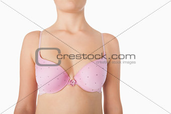 Midsection of woman in pink bra