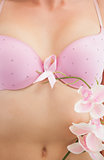 Woman with breast cancer awareness ribbon and flower