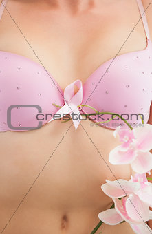 Woman with breast cancer awareness ribbon and flower