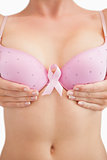 Woman with breast cancer awareness ribbon attached to bra