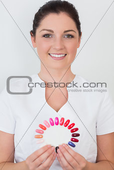 Smiling woman holding nail shades