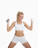 Portrait of woman exercising with dumbbells