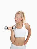 Portrait of young woman exercising with dumbbell
