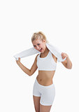 Excited woman in sportswear holding towel around neck