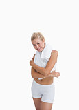 Portrait of happy woman in sportswear holding towel around neck