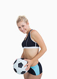 Portrait of happy woman in sportswear with football