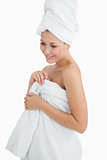 Happy young woman wrapped in towel