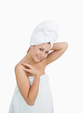 Portrait of happy woman wrapped in towel