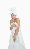 Portrait of embarrassed woman covering herself with towel