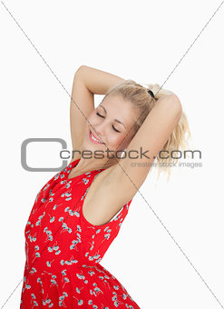Young woman in red summer dress standing