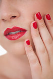 Woman red painted finger nails and red lips