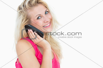 Portrait of happy casual young woman on call