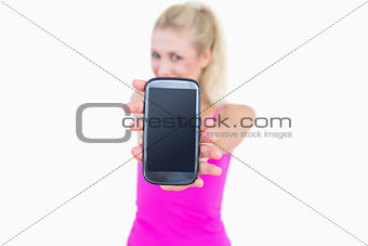 Portrait of casual young woman showing you her new smartphone