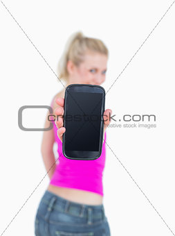 Portrait of casual woman showing you her new smartphone