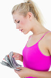 Young casual woman counting us banknotes