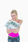 Portrait of happy young woman holding fanned euro banknotes