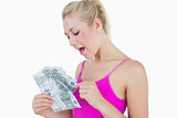 Young casual woman counting euro banknotes