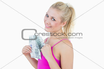 Portrait of happy woman with fanned euro banknotes