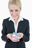 Portrait of business woman holding model house