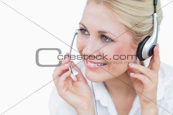 Closeup of young female executive wearing headset