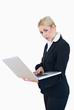 Portrait of young businesswoman using laptop