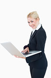 Portrait of happy businesswoman using laptop