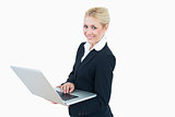 Portrait of happy young businesswoman using laptop