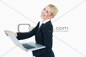 Happy young businesswoman using laptop