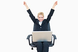 Successful business woman raising hands with laptop