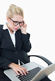 Worried young businesswoman using laptop