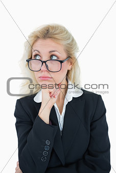 Young thoughtful business woman with hand on chin