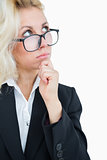 Thoughtful business woman looking up with hand on chin over