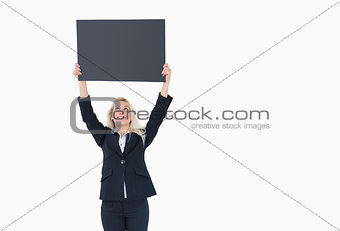 Young business woman holding up empty banner