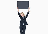 Portrait of young business woman holding up empty banner