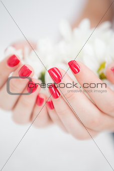 Manicured hands holding flowers