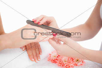 Closeup of woman filing fingernail