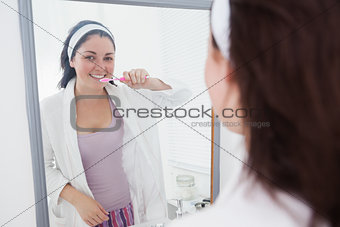 Young woman brushing her teeth